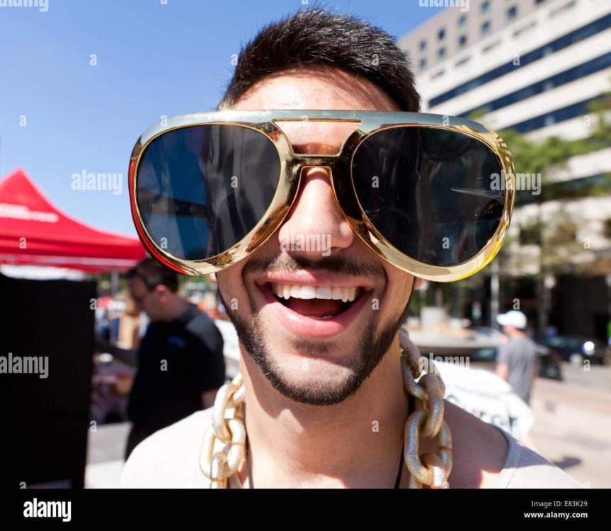 young-man-wearing-funny-oversize-novelty-sunglasses-usa-E83K29.jpg